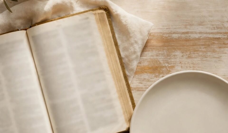An empty plate beside an open Bible and candle, representing fasting as surrender rather than restriction.