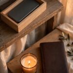 A phone placed face down in a small box beside a candle and closed Bible, representing attention reclaimed on purpose.