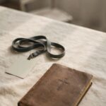 A volunteer lanyard set beside a closed Bible, representing service that may have quietly replaced quiet presence with God.