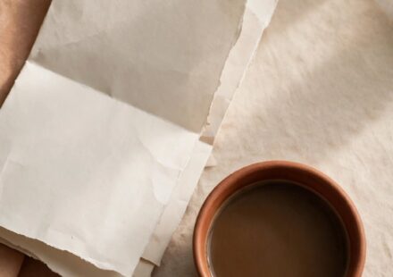A folded church bulletin beside an untouched cup of coffee, representing the tension between faithful service and genuine rest.