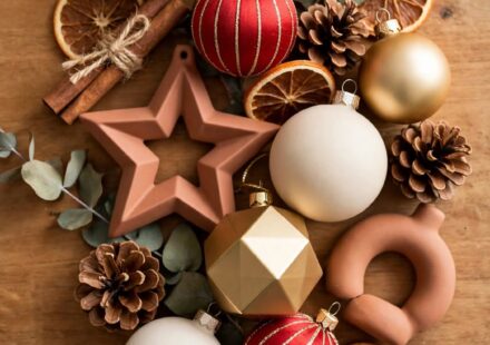 Two different styles of holiday ornaments placed together on a table, representing two family traditions blended into something new.