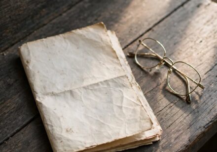 A worn church bulletin folded on a pew in soft light, representing a quiet drift in engagement rather than a dramatic departure.