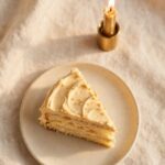 A simple slice of cake with a lit candle, representing genuine, unashamed celebration of good news.