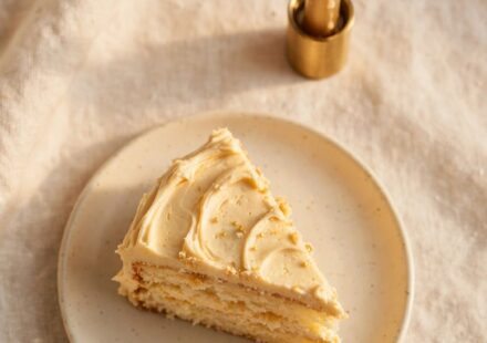 A simple slice of cake with a lit candle, representing genuine, unashamed celebration of good news.