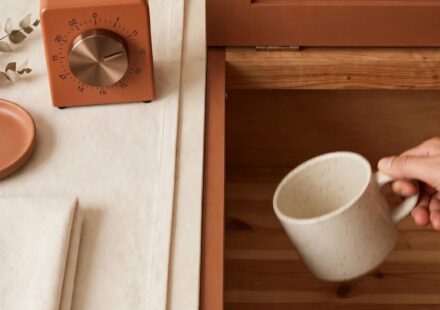 A kitchen timer set to fifteen minutes beside a tidy countertop, representing a small, doable evening rhythm.