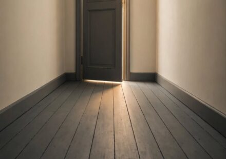 A closed door with a narrow sliver of light through the gap, representing grief and faith after a prayer answered no.