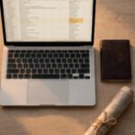 A laptop spreadsheet beside a passport and unopened map, representing a carefully made retirement plan facing an unexpected change of direction.