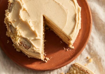 A homemade cake with one uneven side left visible, representing a genuine compliment accepted plainly rather than argued with.